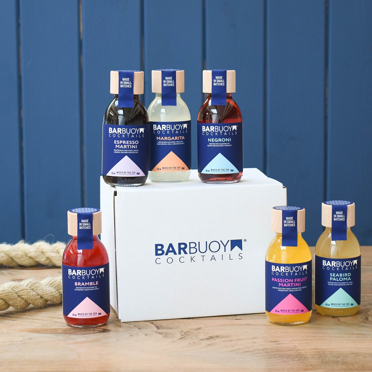 A gift box labeled 'BARBUOY COCKTAILS' with six bottles of ready-to-serve cocktails, including flavors such as Margarita, Passion Fruit Martini, and Espresso Martini.
