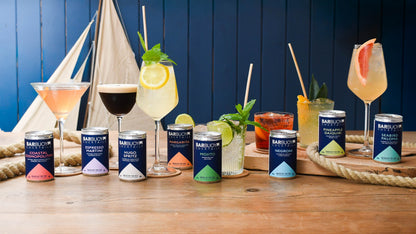 The Bar Buoy cocktail range poured into glasses with each can in front