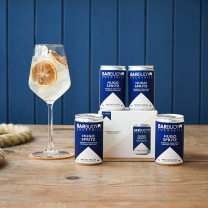 Bar Buoy Hugo Spritz 4 pack box with cans and a served Hugo Spritz in a wine glass