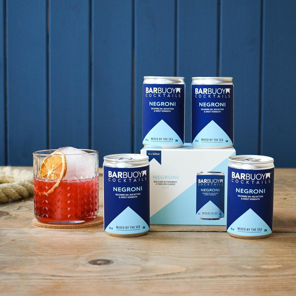 Bar Buoy Negroni 4 pack box with cans and a served Negroni over ice
