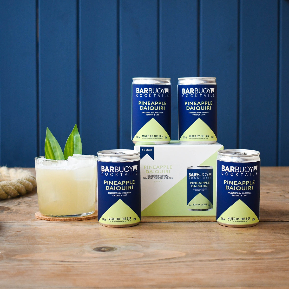 Bar Buoy Pineapple Daiquiri 4 pack box with cans and a served Pineapple Daiquiri over ice