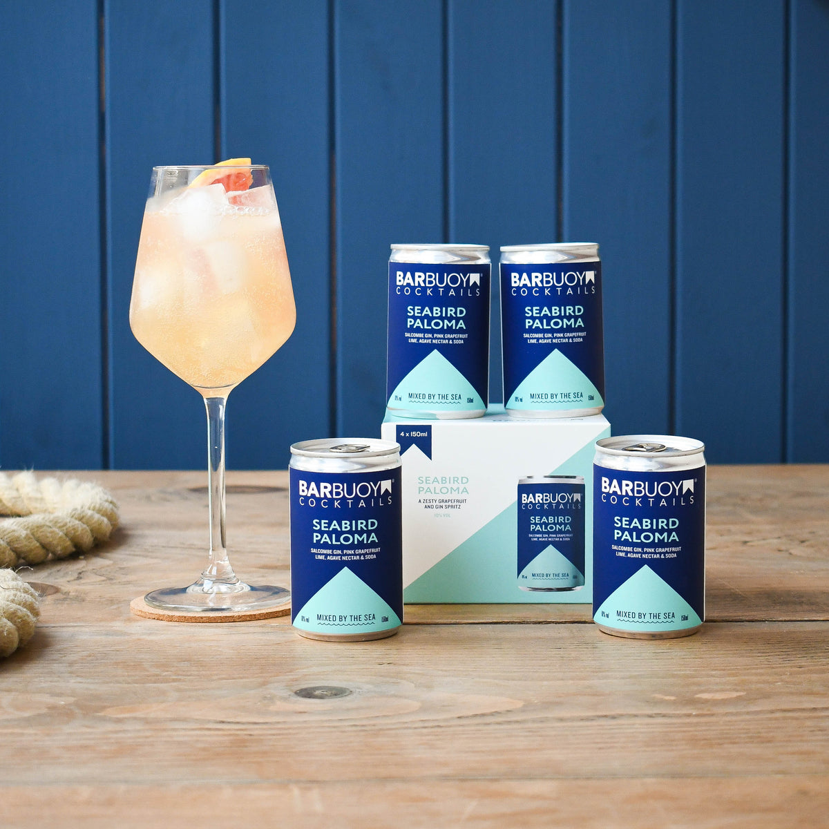 Bar Buoy Seabird Paloma 4 pack box with cans and a served Seabird Paloma in a wine glass