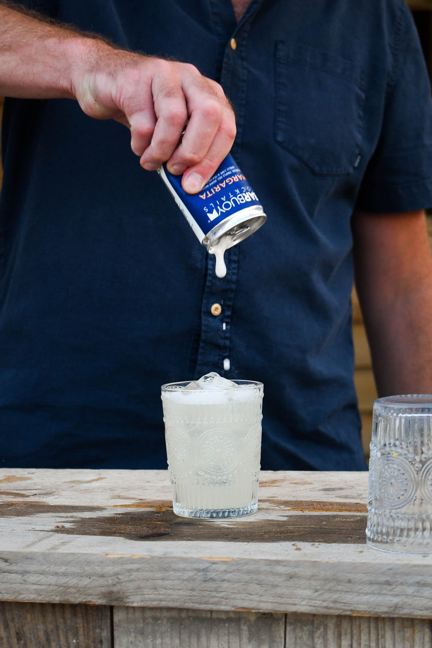 Pouring a Bar Buoy can into a glass of ice at the bar