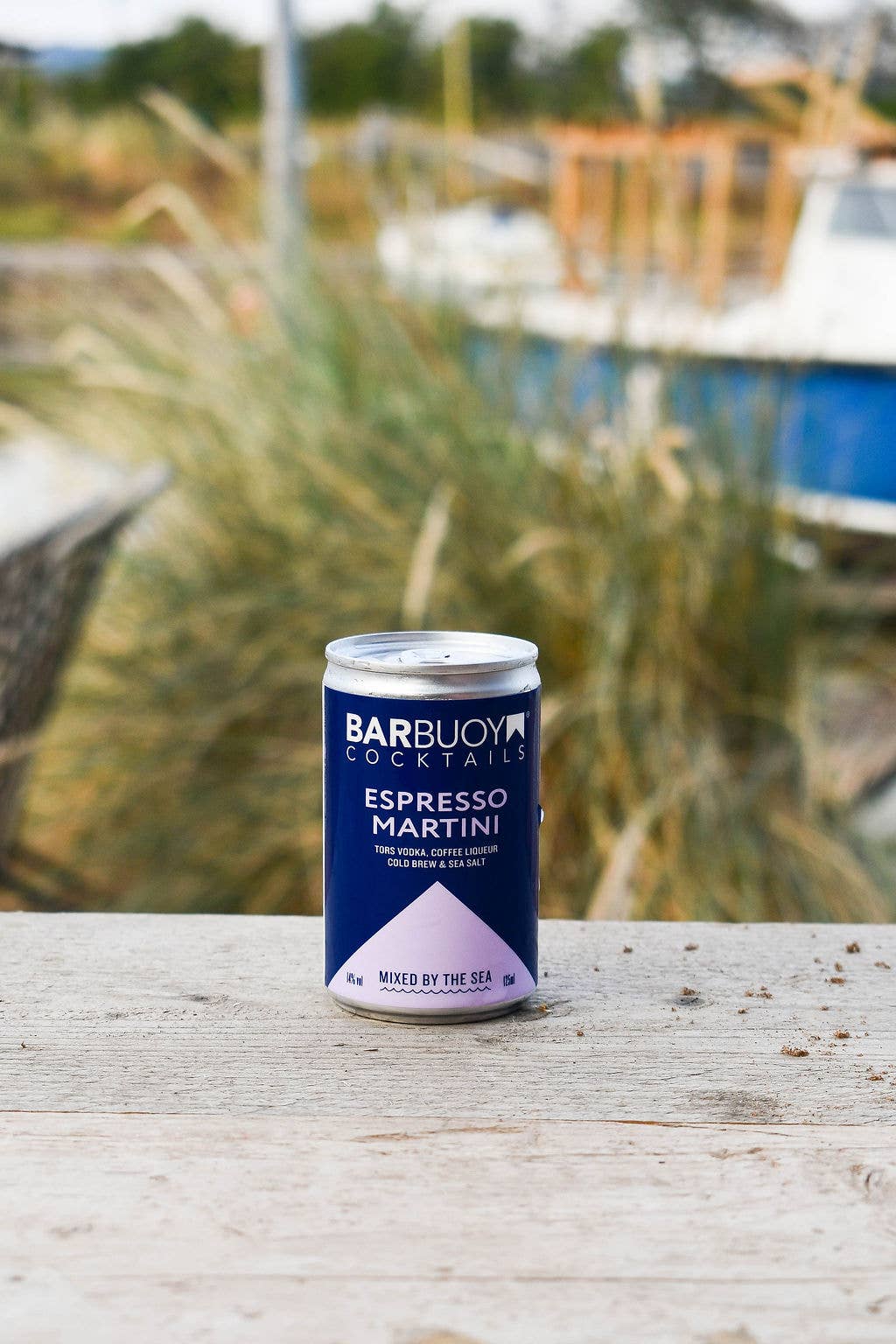 Bar Buoy Espresso Martini can on a wooden table by the coast